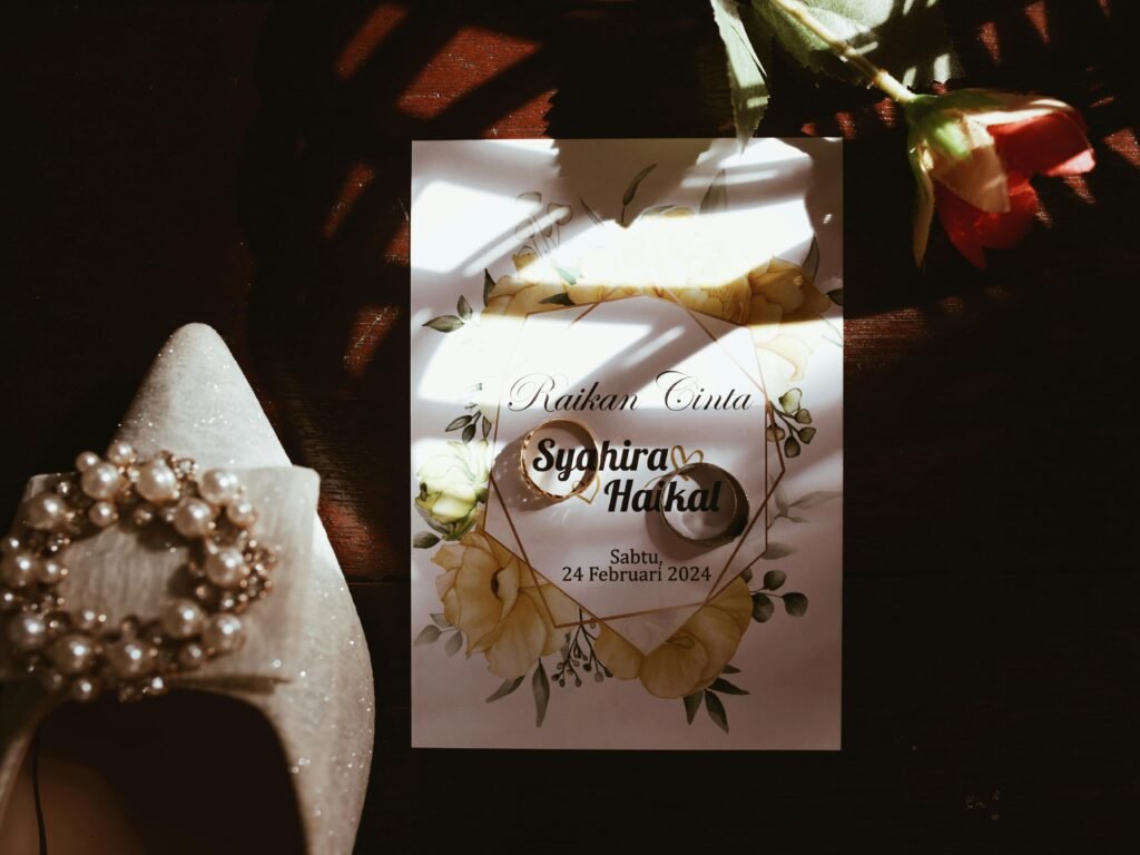 A beautifully styled wedding invitation featuring flowers and rings, perfect for a romantic celebration.